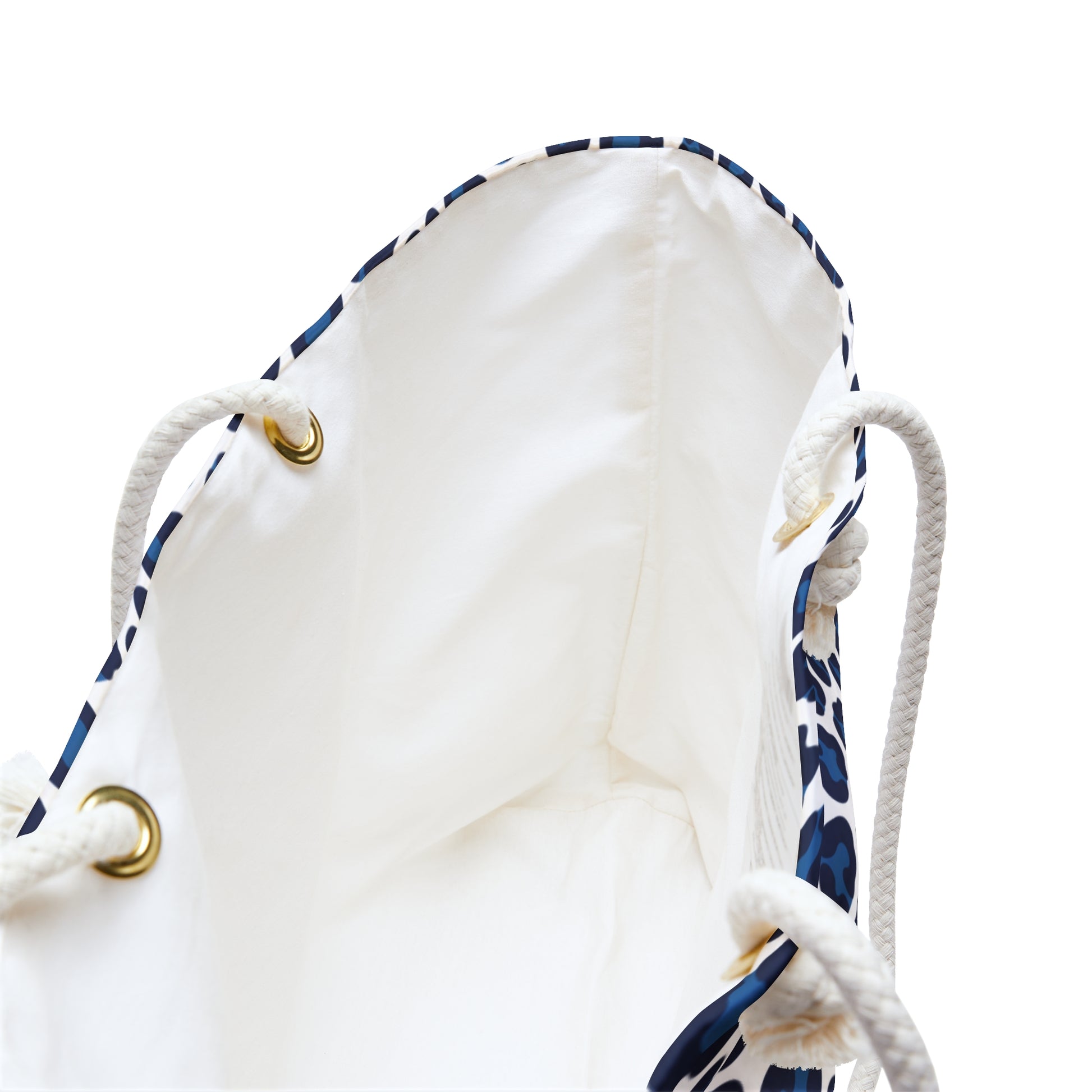 Weekender Bag Blue Cheetah Print featuring a close-up of the sturdy white rope handles with gold rings and a dynamic blue and white animal pattern, embodying a stylish, adventurous travel accessory.