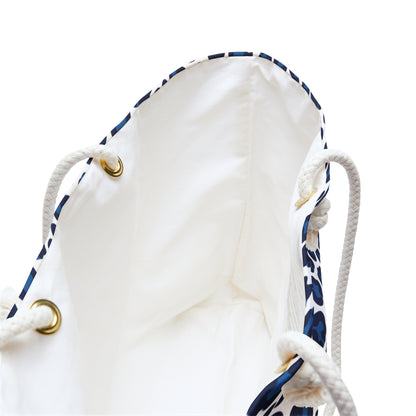 Weekender Bag Blue Cheetah Print featuring a close-up of the sturdy white rope handles with gold rings and a dynamic blue and white animal pattern, embodying a stylish, adventurous travel accessory.