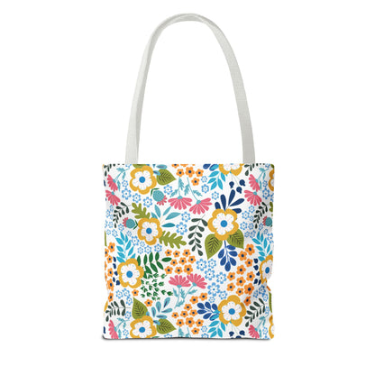 Floral Tote Bag featuring a vibrant floral pattern with daisies and assorted blooms, white handles, designed for summer outings. Durable polyester body, reinforced stitching, spacious with boxed corners; perfect for joyful, stylish use.