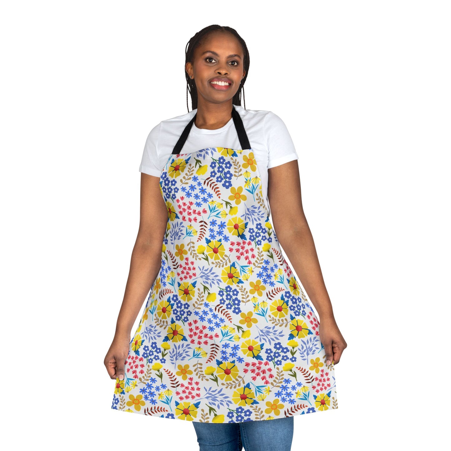 Woman wearing a vibrant Apron Floral Design, showcasing its multicolored floral pattern over casual attire. The apron, made from polyester canvas, emphasizes comfort and style, reflecting FireBrook Essentials' uplifting design ethos.