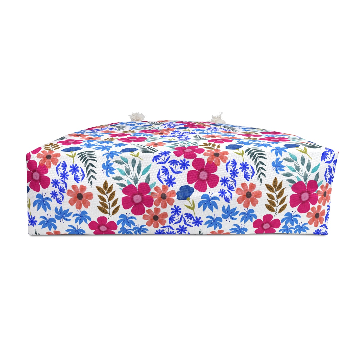 Weekender Bag adorned with a bright floral pattern, featuring tassels at corners. This stylish, cushioned accessory reflects FireBrook Essentials' joyful design ethos, perfect for enhancing travel experiences.