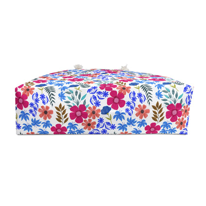 Weekender Bag adorned with a bright floral pattern, featuring tassels at corners. This stylish, cushioned accessory reflects FireBrook Essentials' joyful design ethos, perfect for enhancing travel experiences.