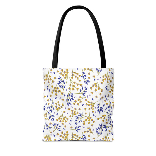 Floral Tote Bag from FireBrook Designs features a botanical pattern with golden yellow and deep blue sprigs on a white background, complemented by black handles, perfect for joyful, stylish outings.