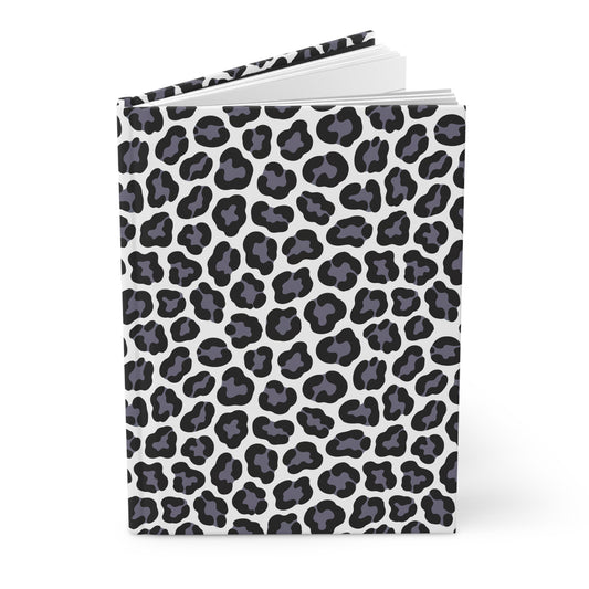 HARDCOVER JOURNAL, MATTE, RULED, 5X7, SEWN BIND, CLEAN-TEAR PAGES – LEOPARD: A stylish black-and-gray leopard spot cover on white, slightly open, revealing blank pages within.