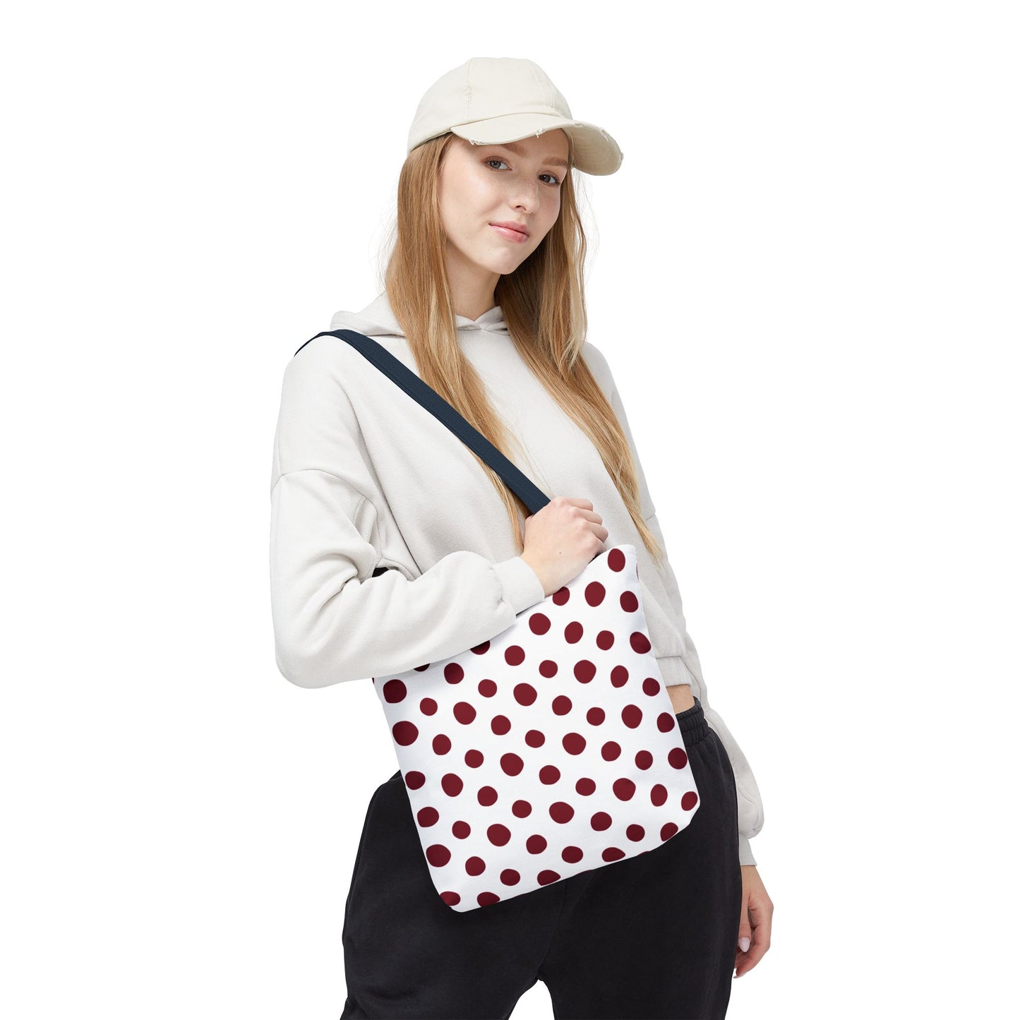 Burgundy Polka Dots Tote Bag held by a woman, showcasing its white and red polka dot design and sturdy cotton handles, embodying FireBrook Essentials' blend of style and functionality for everyday use.