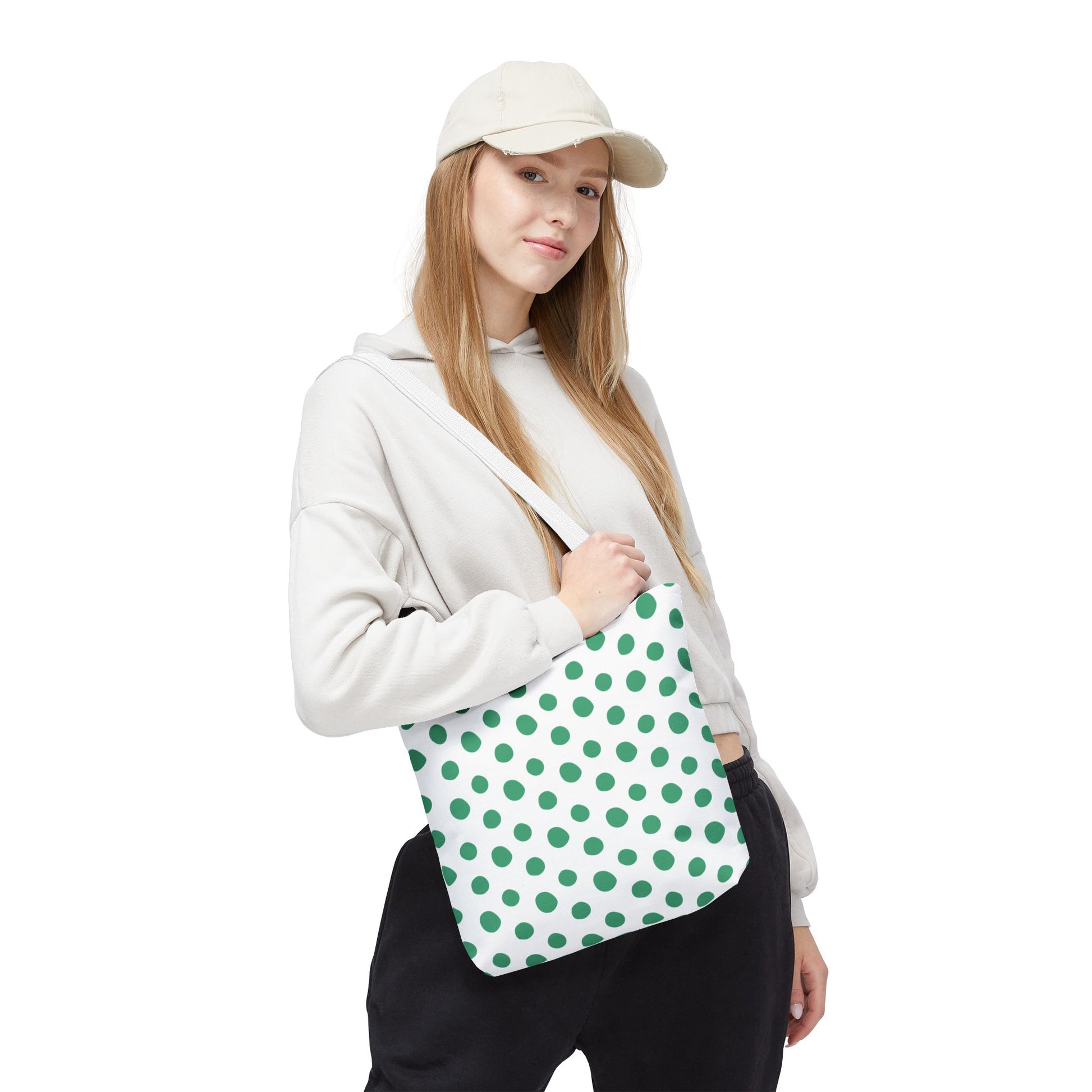Green Polka Dots Tote Bag featured prominently, held by a woman in casual attire. The bag's playful design embodies FireBrook Designs' ethos of stylish, joyful accessories for everyday use.