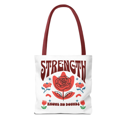 Strength Knows No Bounds Tote Bag, white with red text and floral design, featuring durable red handles and spacious boxed corners. Perfect for everyday use.