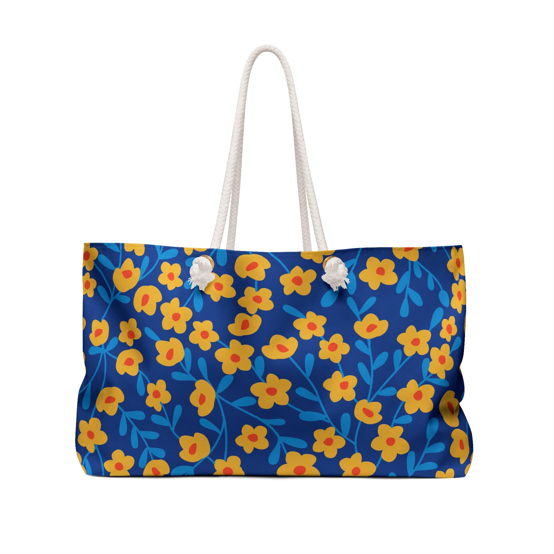 Weekender Bag with vibrant floral print on deep blue fabric, featuring thick white rope handles through metal eyelets. Spacious and stylish, ideal for travel, embodying FireBrook Designs' uplifting, practical style.