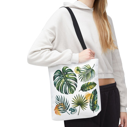 Tropical Leaves Tote Bag featuring a hand holding a leaf-patterned section, highlighting its spacious and durable design, ideal for beach or casual use, embodying FireBrook Designs' stylish and uplifting essentials.