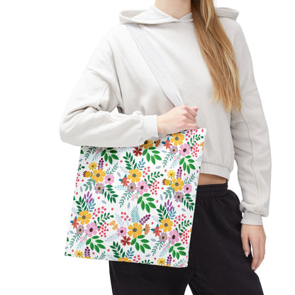 Spring Floral Patch Tote Bag: A person wears a light hoodie and dark pants, holding a large tote with a vibrant floral-and-leaf pattern, perfect for summer outings and beach trips.