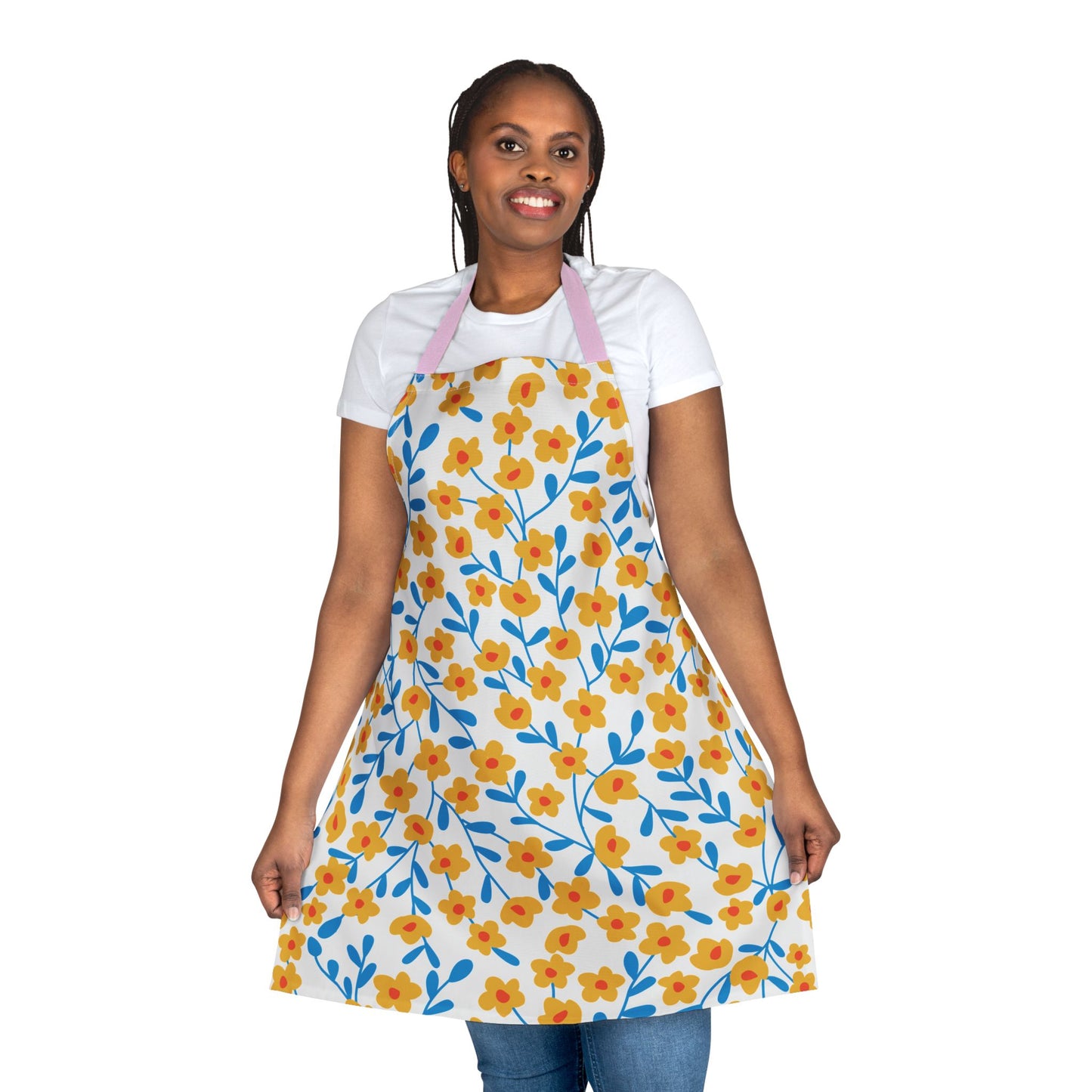 Model wearing Floral Apron with yellow flowers and blue stems, featuring a pink neck strap. The apron embodies FireBrook Designs' style, offering comfort and vibrant design for joyful cooking and crafting experiences.