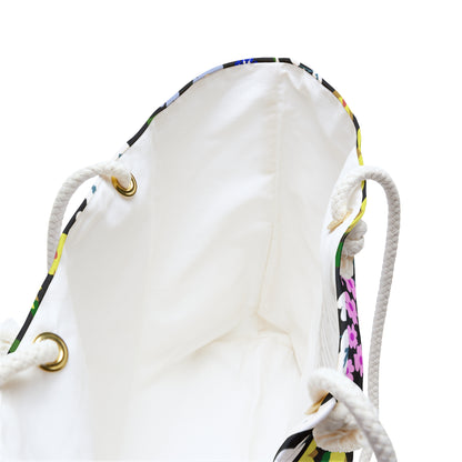 Weekender Bag with a cream-lined interior and braided rope handles through brass grommets, showcasing a hint of colorful floral print at the top edge, perfect for stylish travel.