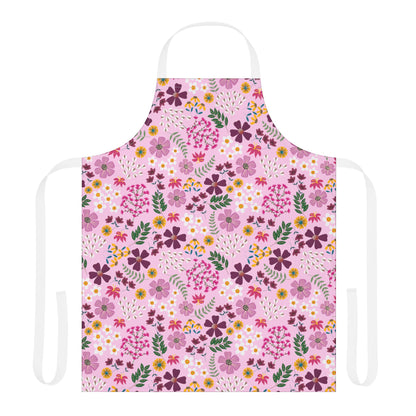 Floral Apron with a repeating floral pattern on light pink fabric. Features white neck and waist ties, designed for comfort and style, embodying FireBrook Essentials' commitment to joyful, practical living.