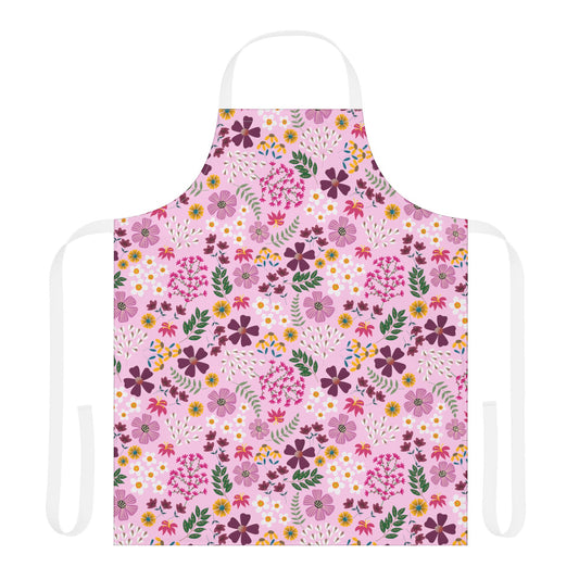 Floral Apron with a repeating floral pattern on light pink fabric. Features white neck and waist ties, designed for comfort and style, embodying FireBrook Essentials' commitment to joyful, practical living.