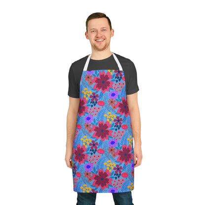 A young man wears a Floral Apron with vibrant blossoms, showcasing FireBrook Designs' signature blend of comfort and style, ideal for culinary or creative pursuits.