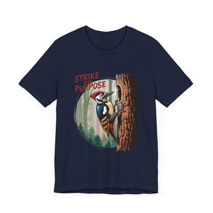 Woodpecker: Strike with a Purpose Bella+Canvas Unisex T-Shirt features a cartoon woodpecker on a tree, embodying motivation and uniqueness, ideal for nature lovers and casual wear.