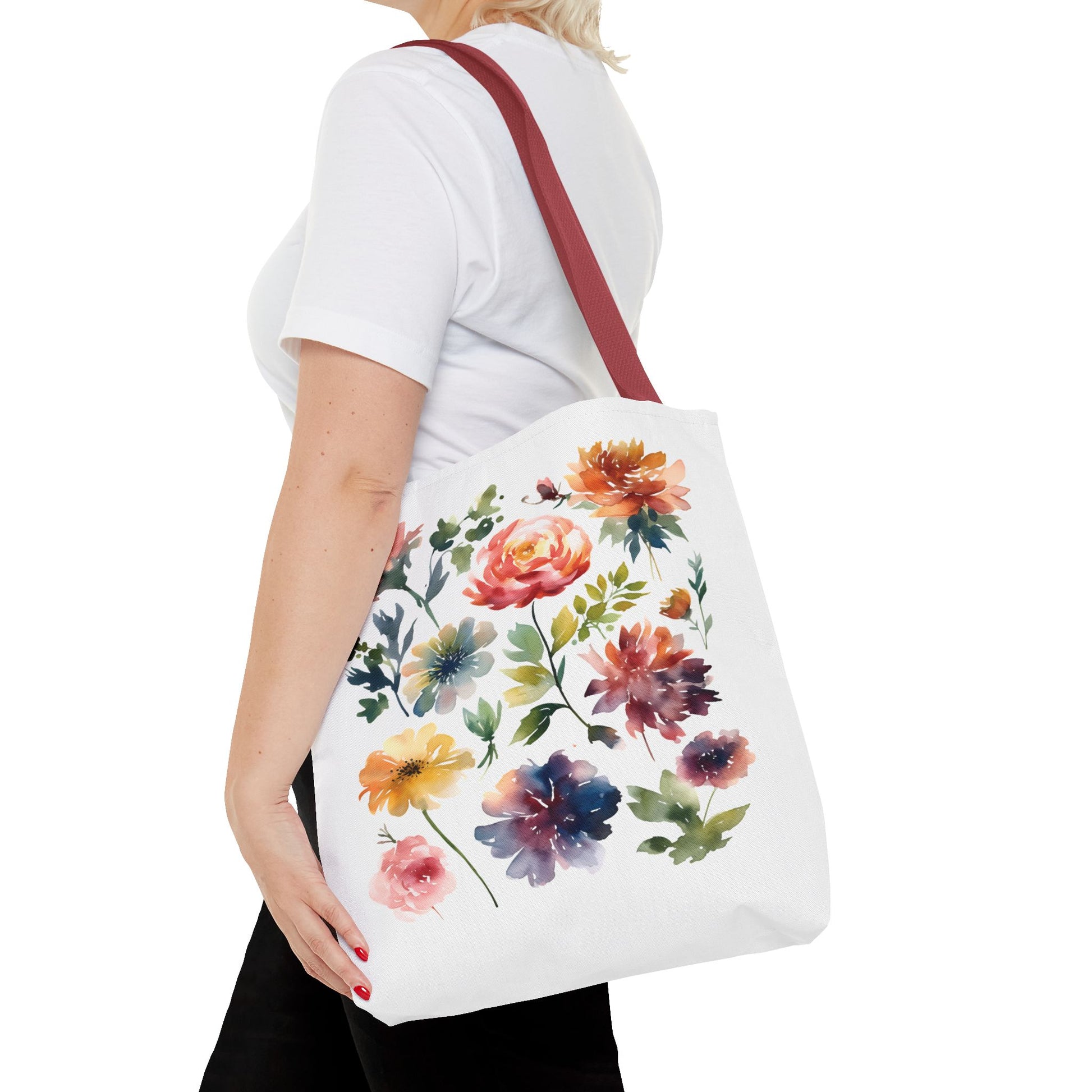Watercolor Floral Tote Bag: A woman carries a stylish tote bag featuring a vibrant floral design, perfect for daily errands and outdoor adventures.