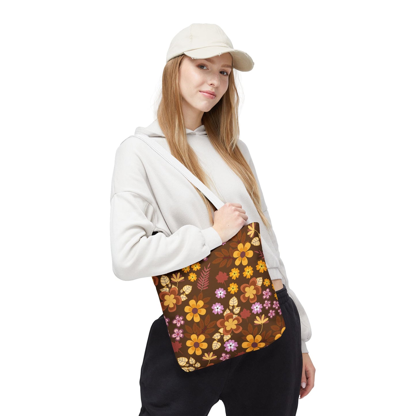 Floral Tote Bag featuring a retro-inspired floral pattern in warm autumn tones, carried by a woman in casual attire. Ideal for stylish, joyful outings, echoing FireBrook Designs' focus on comfort and positivity.