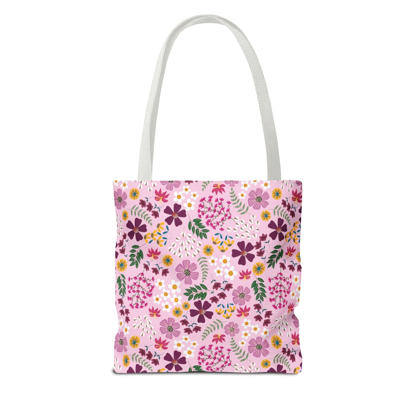 Rose Garden Blush Tote Bag with a pink canvas-style body, adorned with a vibrant floral pattern, featuring white shoulder straps. Perfect for daily use, reflecting FireBrook Essentials' blend of style and durability.