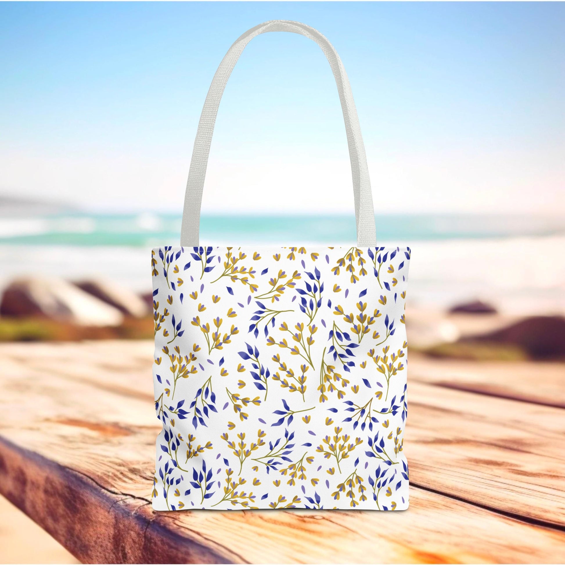 Floral Tote Bag on a wooden surface with a botanical pattern in mustard-gold and muted cobalt blue, embodying FireBrook Designs' uplifting style, ideal for summer outings and market trips.