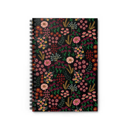 The Floral Spiral Notebook features a dark background with vibrant floral patterns in pink, burgundy, mustard yellow, and green, embodying FireBrook Essentials' uplifting design ethos, perfect for inspiring creativity and organization.