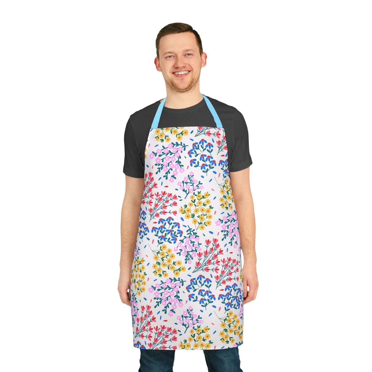 Floral Apron featuring vibrant flower patterns, worn by a smiling man. This stain-free, polyester canvas apron from FireBrook Essentials offers comfort with light blue straps, perfect for baking, cooking, or hosting.