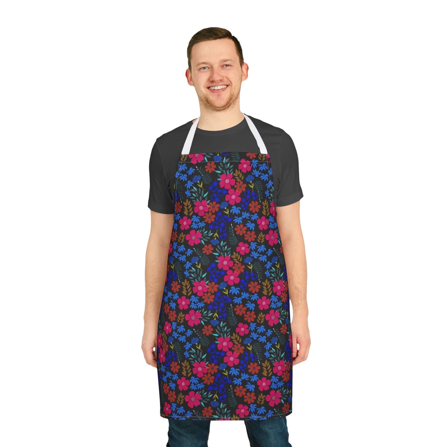 Man wearing FireBrook Designs' Apron Floral Design, showcasing a vibrant floral pattern on a black polyester canvas, complete with white shoulder straps, ideal for stylish and comfortable kitchen or crafting activities.