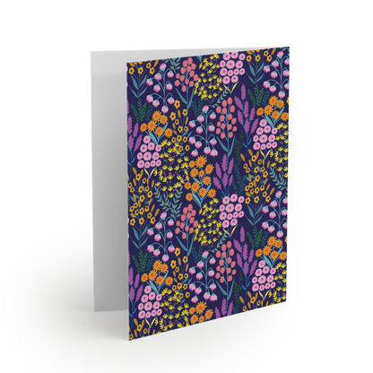 Floral Wildflower Greeting Cards — Pack of 8/16/24, featuring a vibrant floral pattern on the cover. The card is slightly open, revealing a blank interior, ready for your personalized message.