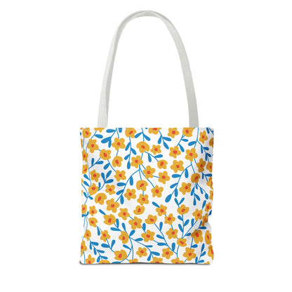 Buttercup Cream Tote Bag with a vibrant floral pattern of yellow-orange flowers and blue stems, featuring long white straps. Ideal for summer outings, enhancing joy and style from FireBrook Designs.