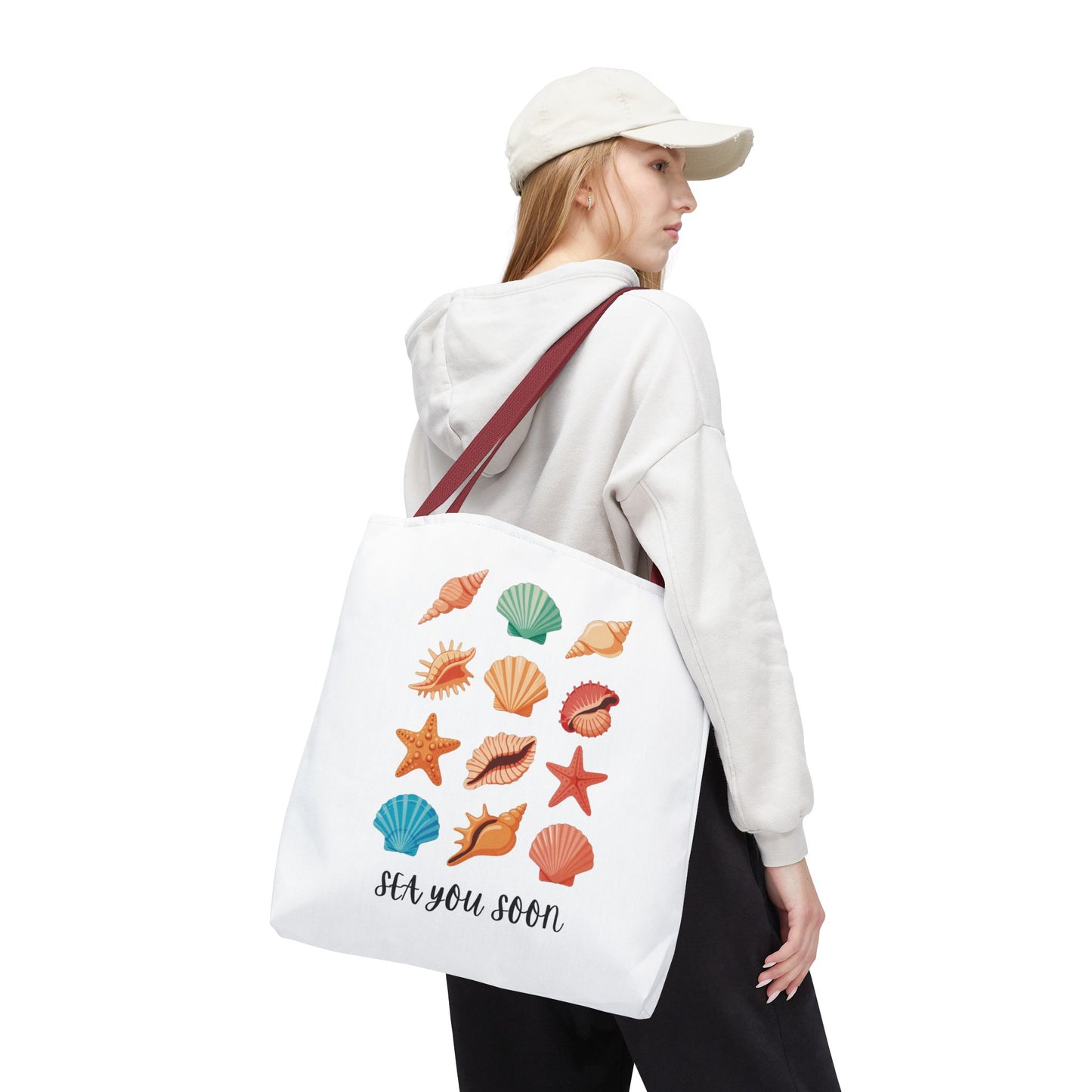 Sea You Soon Sea Shells Tote Bag displaying a beachy design with sea shells, ideal for summer outings. Features durable polyester, reinforced handles, and boxed corners for spaciousness. Perfect for ocean and nature lovers.