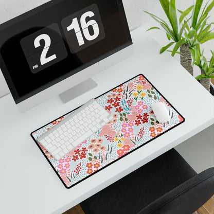 Garden Floral Pattern Desk Mat on a white desk, featuring vibrant floral designs. Positioned beneath a white keyboard and mouse, with a potted plant nearby, enhancing workspace elegance and joy.