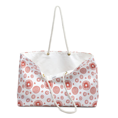 Weekender Bag - Red Swirls and Circles Design: A close-up shows durable polyester fabric with bold red patterns and sturdy rope handles, embodying FireBrook Essentials' stylish, practical aesthetic for joyful, easy travel.