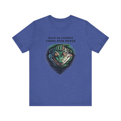 Crocodile: Walk in Silence, Strike with Purpose Bella+Canvas Unisex T-Shirt featuring a cartoon crocodile design, embodying stealth and determination, perfect for casual wear or as a bold statement piece.