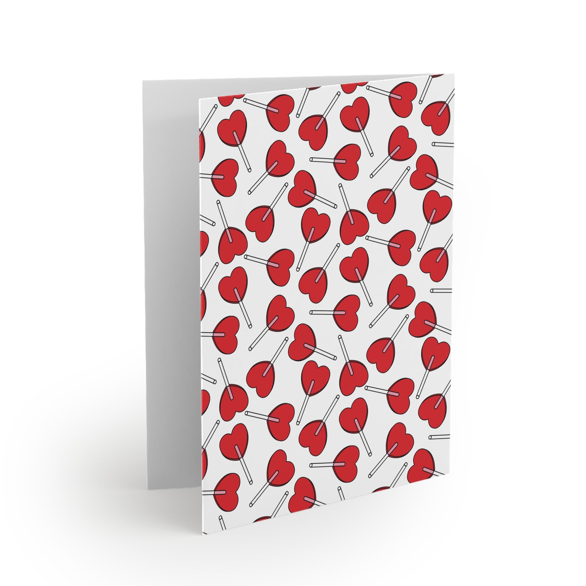 Love Greeting Cards — Pack of 8/16/24, featuring a matte-finish with a red lollipop pattern, partially open, showcasing FireBrook Designs' cheerful, uplifting style. Includes a matching white envelope.
