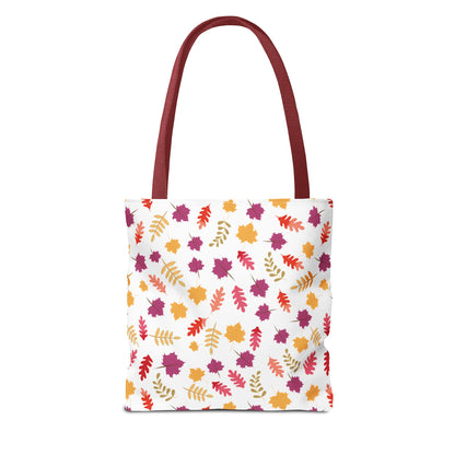 Autumn Leaves Tote Bag from FireBrook Designs features a white body with a vibrant pattern of stylized autumn leaves, burgundy handles, and reinforced stitching for durability, perfect for daily essentials.