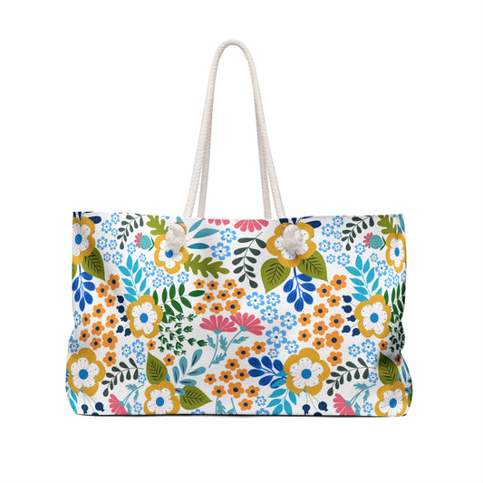 Weekender Bag with a vibrant floral pattern on a white background, featuring thick white rope handles and a spacious design, ideal for stylish travel and overnight stays, embodying FireBrook Designs' uplifting aesthetic.