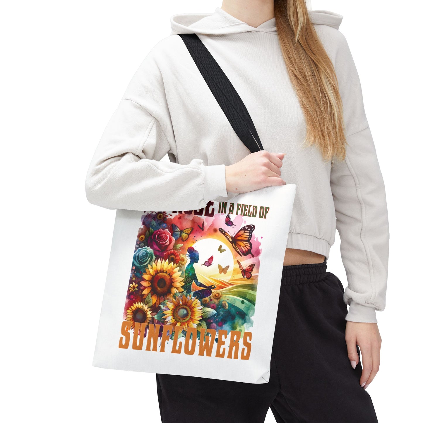 Woman holding 'Be the Rose in a Field of Sunflowers' Tote Bag, showcasing its nature-inspired floral design and durable build for stylish everyday use.