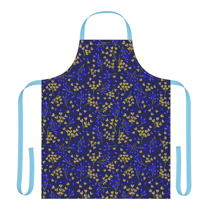Floral Apron from FireBrook Designs features a deep blue fabric adorned with a yellow and cobalt leaf motif, light-blue neck loop, and waist ties, blending comfort and style for joyful kitchen moments.
