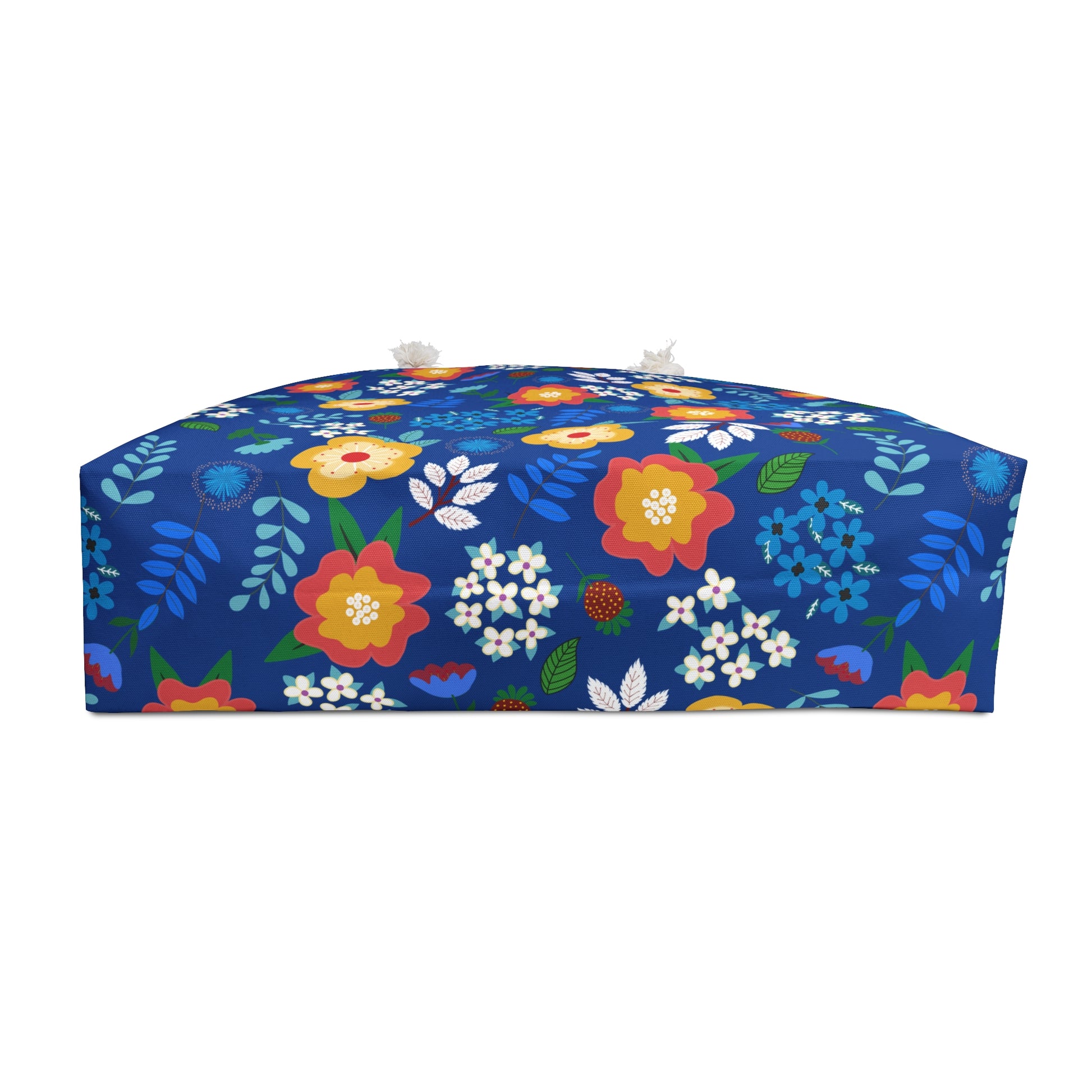 Weekender Bag with vibrant floral print on cobalt blue, featuring tassels. Ideal for stylish travel, showcasing FireBrook Designs' commitment to joyful, original designs.