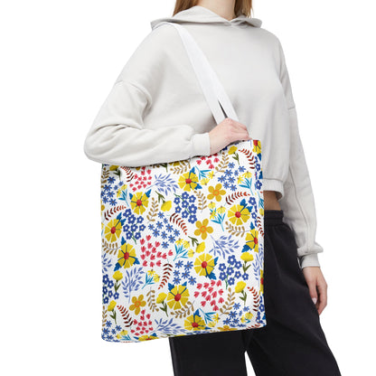 Floral Tote Bag featuring a vibrant floral pattern with yellow daisylike blooms, carried over the shoulder. Ideal for summer outings, this bag embodies FireBrook Designs' uplifting and joyful design ethos.