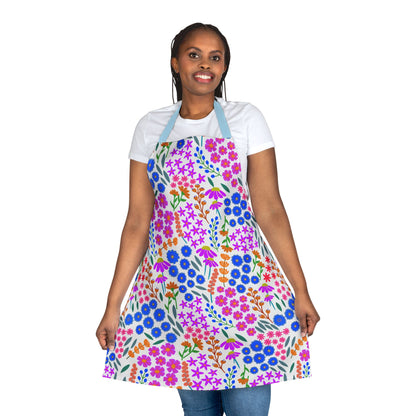 Person wearing a Floral Apron with a vibrant multicolored pattern and light blue neck straps, highlighting its stylish design and comfort. Perfect for cooking or crafting, reflecting FireBrook Essentials' joyful aesthetic.