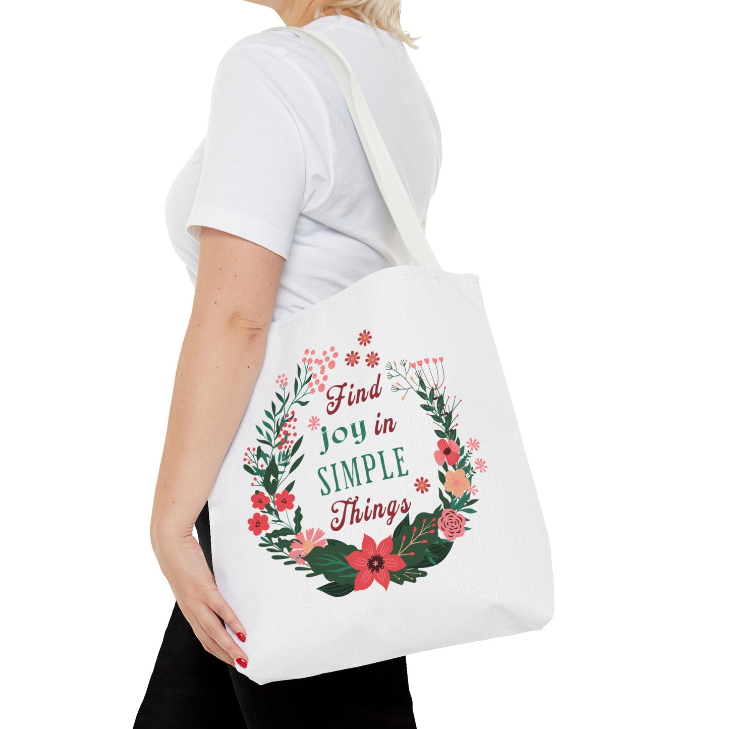 Find Joy in Simple Things Tote Bag with floral design, held by a woman in a white shirt, showcasing its stylish and practical features.