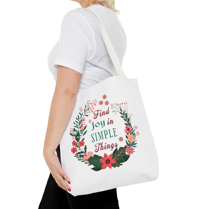 Find Joy in Simple Things Tote Bag with floral design, held by a woman in a white shirt, showcasing its stylish and practical features.