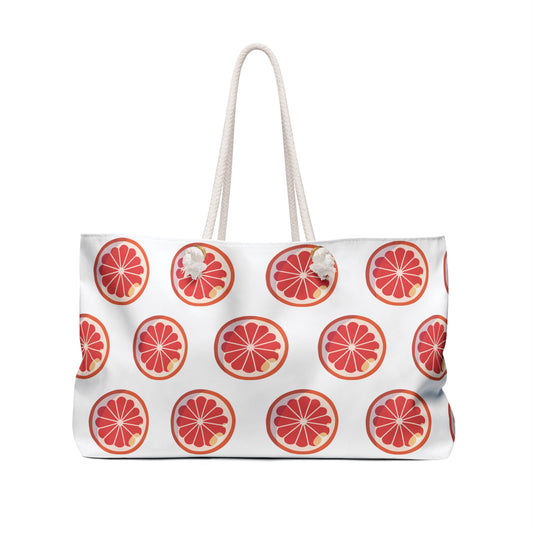 Weekender Bag Orange Slices Print features vibrant orange slice patterns, rope handles, and a tassel, perfect for summery adventures. Crafted from durable polyester, it offers ample space for weekend getaways.