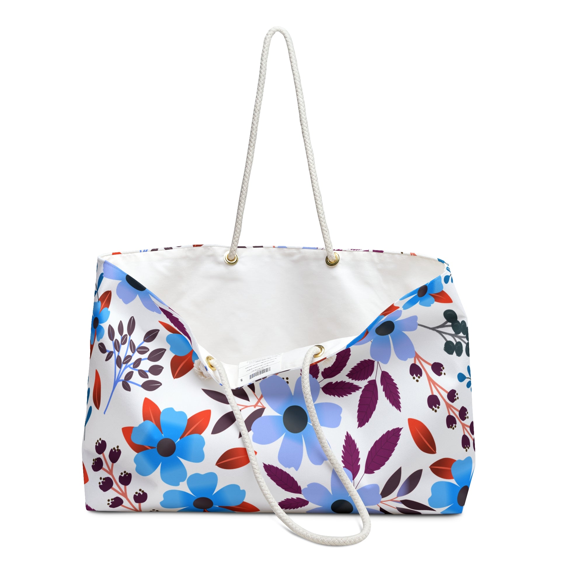 Weekender Bag with thick white rope handles features a vibrant floral pattern in blue, red, and purple on a white background, perfect for stylish weekend getaways.