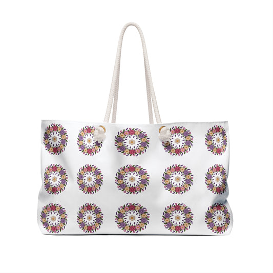 Crochet Floral Weekender Bag with intricate crochet floral pattern, cream-colored backdrop, rope handles, and spacious design, perfect for stylish weekend getaways and travel.