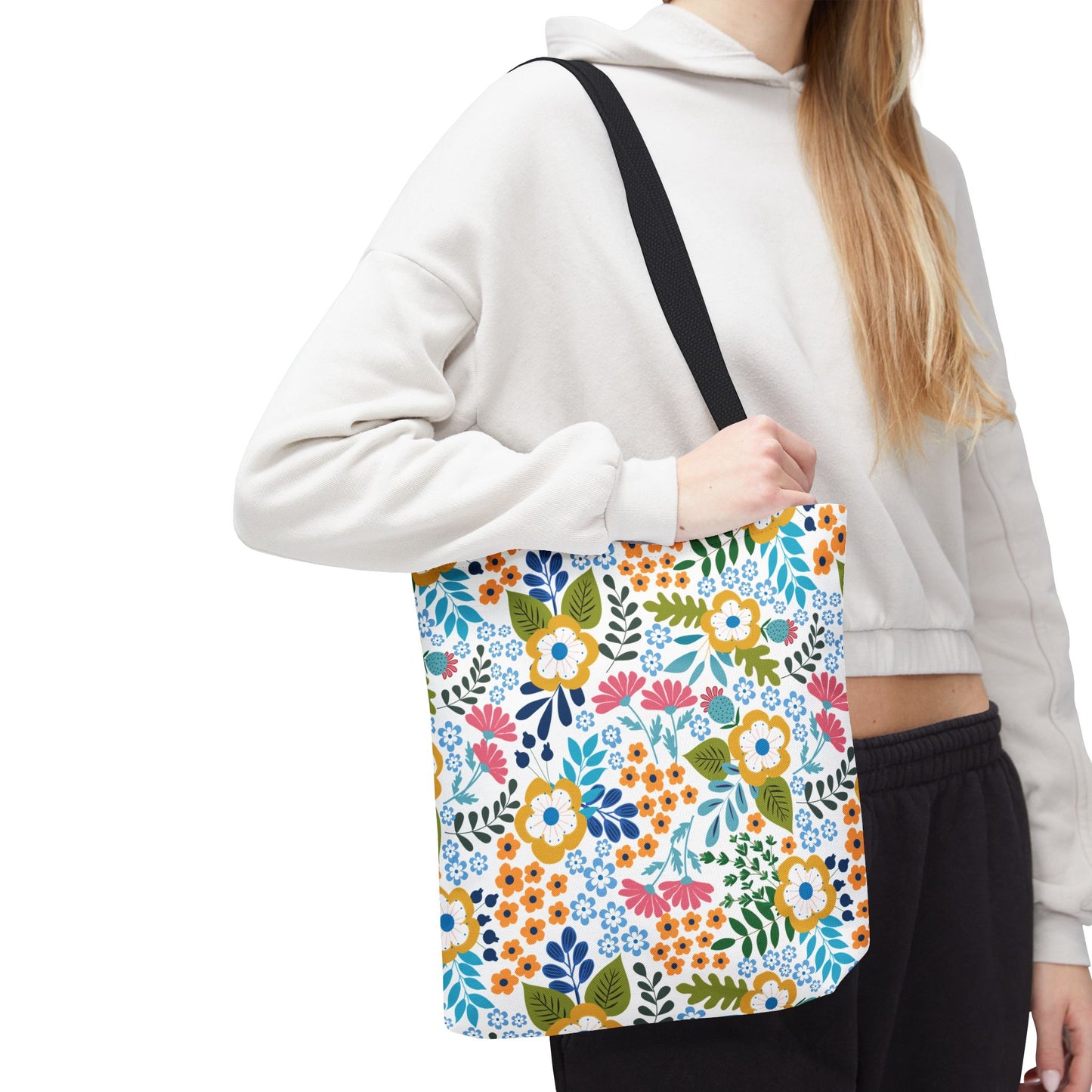 Floral Tote Bag: A vibrant shoulder tote featuring a bright, stylized floral pattern with yellow, blue, pink, and green blossoms, perfect for uplifting summer outings. It's designed for durability and cheerfulness.