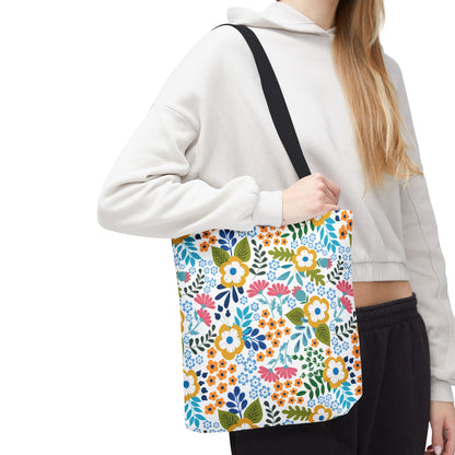 Floral Tote Bag: A vibrant shoulder tote featuring a bright, stylized floral pattern with yellow, blue, pink, and green blossoms, perfect for uplifting summer outings. It's designed for durability and cheerfulness.