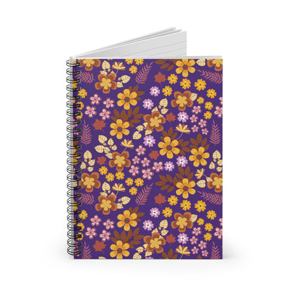 Floral Spiral Notebook with vibrant autumnal floral pattern on a deep purple cover, standing upright. Sleek metal spiral binding and visible white lined pages enhance ease of use. Perfect for creative note-taking.