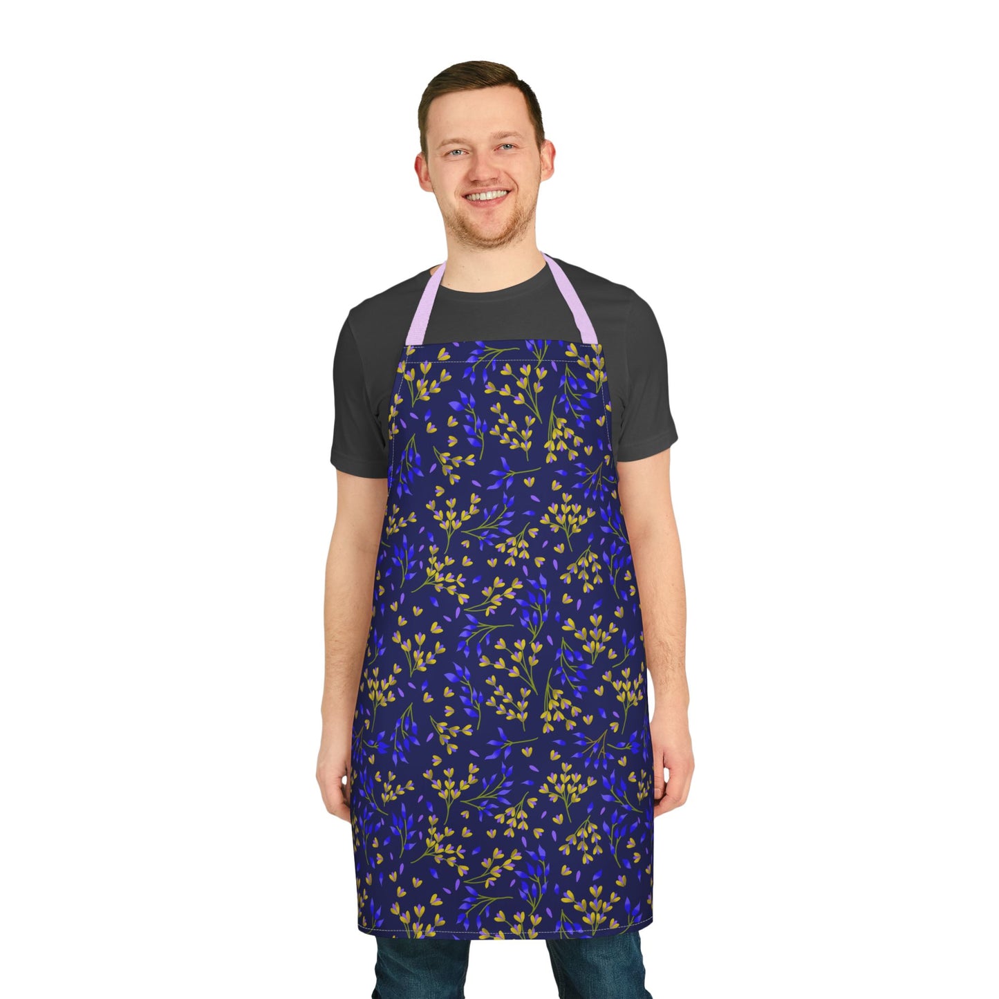 Floral Apron: A young man models a deep blue apron with yellow and cobalt-blue sprigs, featuring a lavender neck strap, highlighting FireBrook Essentials' stylish, comfortable design for joyful everyday use.